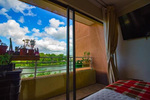 a room with a window with a view of a river at Hermosa vista laguna tres Pascualas in Concepción