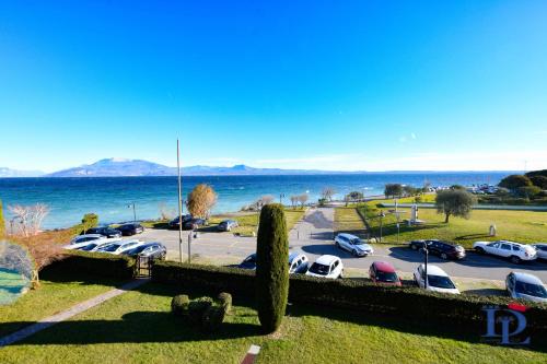 a view of a parking lot with cars parked at DesenzanoLoft Official Partner Homes & Villas by Marriott Bonvoy - Eden Lake view and privat beach renovated in 2025 in Sirmione