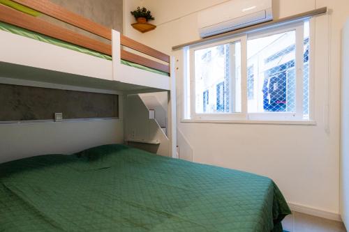 a bedroom with a bunk bed and a window at SUH Copacabana 79 New Beach in Rio de Janeiro
