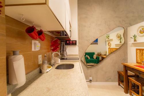 a kitchen with a sink and a mirror on the wall at SUH Copacabana 79 New Beach in Rio de Janeiro