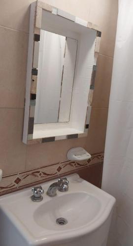 a bathroom with a sink and a mirror at Travel ART! in Mar del Plata