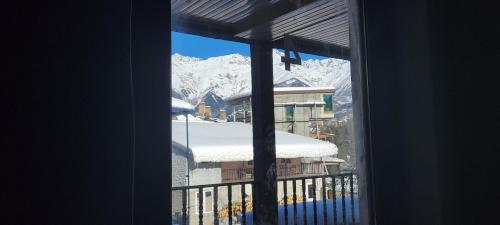 a view of a snow covered mountain from a window at Hotel Maria in Mestia