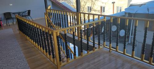 a metal railing on a balcony with a table at Hotel Maria in Mestia