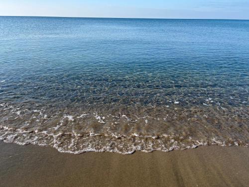 a view of the water and the beach at Casa Zefiro, tra pineta e mare! in Fregene