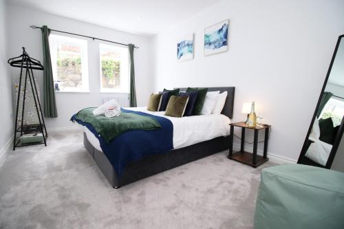 a bedroom with a bed and a window at Casa di pietra - Cardiff City centre apartment with patio, Free private parking in Cardiff