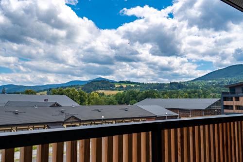 a view from the balcony of a building with mountains at Tee House - Forest Apartment Čeladná in Čeladná