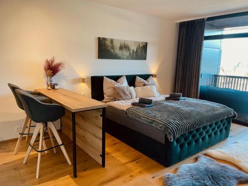 a bedroom with a bed and a desk and a deskablish at Tee House - Forest Apartment Čeladná in Čeladná