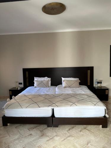 a bedroom with a large bed with a black headboard at Private Riad Alemania in Marrakesh - Pool - Rooftop in Marrakech