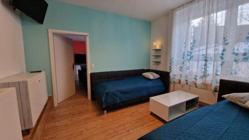 a bedroom with a bed and a couch in a room at Familienfreundliche große Fewo Peter in Bärenstein bis 5 Personen in Bärenstein
