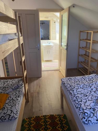 a room with two bunk beds and a bathroom at Skh 2 in Praid