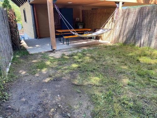 a porch with a table and a hammock on it at Skh 2 in Praid