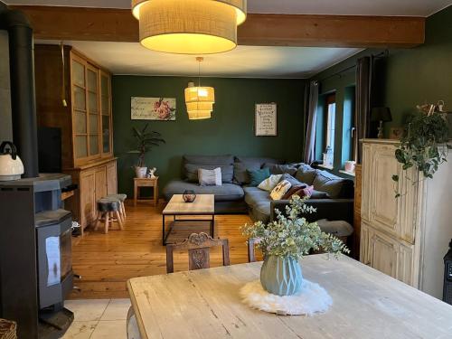 a living room with a couch and a table at Les Pierris in La-Roche-en-Ardenne