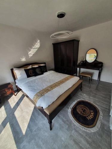 a bedroom with a large bed and a mirror at Ostoja Bachus in Sawin