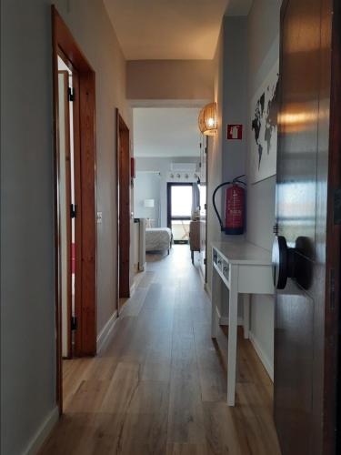 a hallway with a desk and a room at Guadiana Sea View Apartment in Monte Gordo