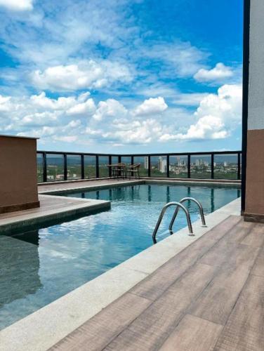 a swimming pool on top of a building at SkyHome Flats Palmas - Cosmopolitan Home & Office in Palmas