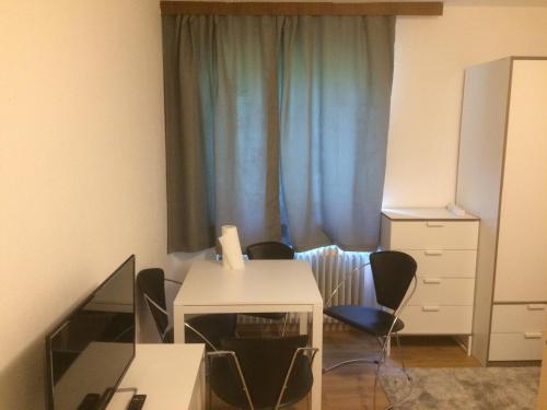 a room with a desk with chairs and a window at Grubhof in Sankt Martin bei Lofer