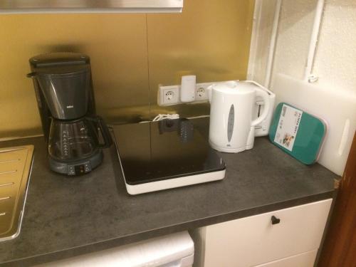 a kitchen counter with a blender and a laptop on it at Grubhof in Sankt Martin bei Lofer
