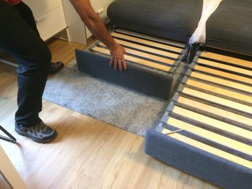 a man is putting a mattress on a bed at Grubhof in Sankt Martin bei Lofer