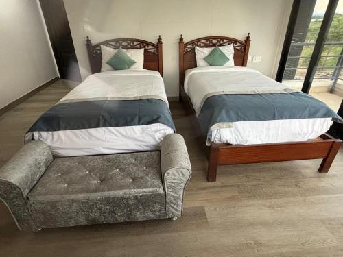 a bedroom with two beds and a couch in it at SuCasa Villa located in Maiyan Nanyuki in Nanyuki