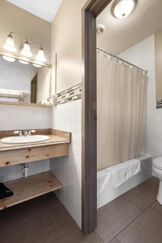 a bathroom with a sink and a toilet and a shower at Caberfae Peaks Ski & Golf Resort in Harrietta