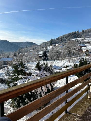 - une vue sur une vallée enneigée depuis un banc dans l'établissement CHALET CATHOGUI, à Gérardmer