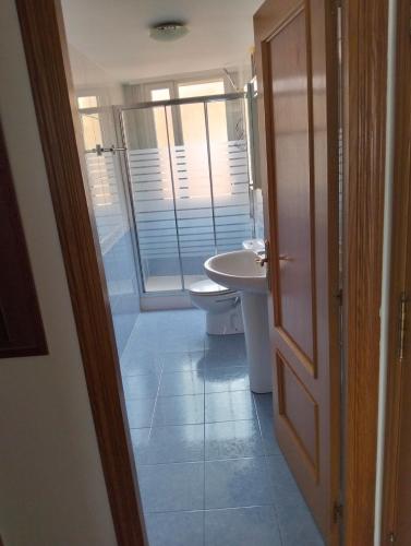a bathroom with a toilet and a sink at La Jara in Fuenmayor