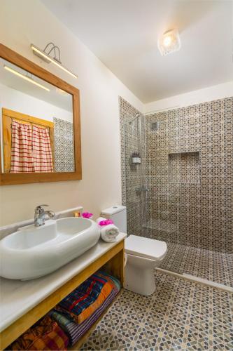 a bathroom with a sink and a toilet and a shower at Fidanka Hotel in Kalkan