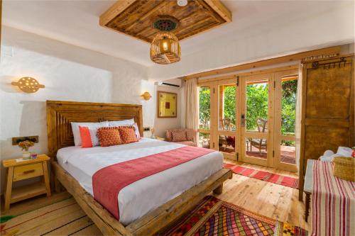 a bedroom with a large bed and a window at Fidanka Hotel in Kalkan