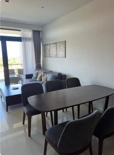 a living room with a couch and a table and chairs at 2BR Family Apartment Spectacular Scenery in Da Nang