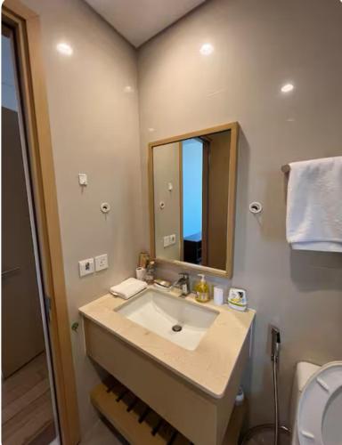 a bathroom with a sink and a mirror at 2BR Family Apartment Spectacular Scenery in Da Nang