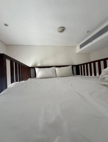 a bedroom with a large white bed with pillows at 2BR Family Apartment Spectacular Scenery in Da Nang