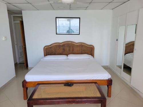 een bed in een kamer met een houten bedframe bij Vacation Home with water views in every room! in Cartagena