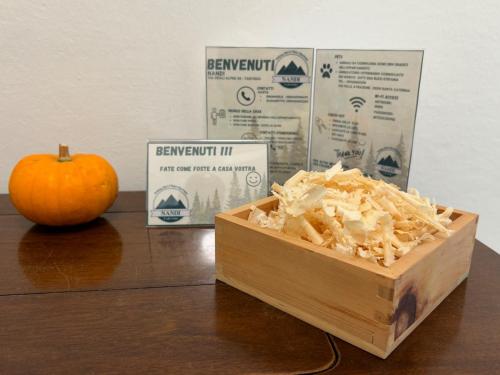 a box of food sitting on a table next to an apple at Nandi-HolidaySport&Relax-Apt in Tarvisio