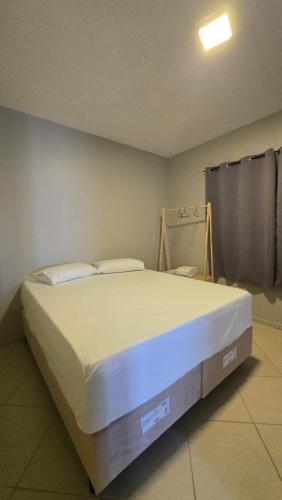 a bedroom with a large bed in a room at Estação Hotelaria in São Gabriel