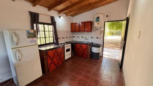 a kitchen with a white refrigerator and a tile floor at casa en costa del este para 5 personas in Costa del Este