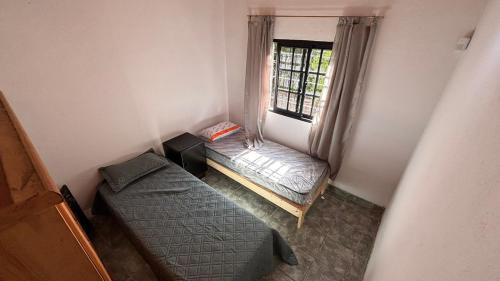 a small room with a bed and a window at casa en costa del este para 5 personas in Costa del Este