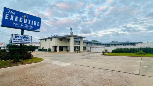 a building with a blue evacuation sign in front of it at Executive Inn and Suites Houston in Houston
