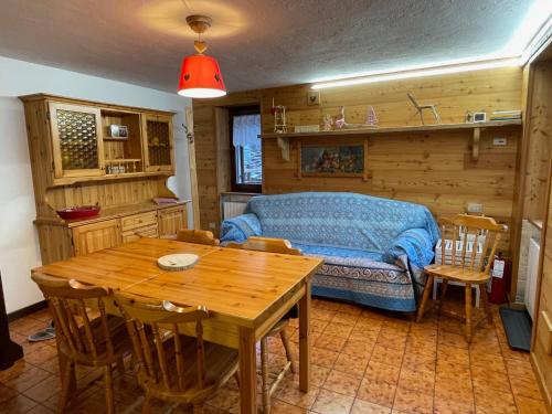 a bedroom with a bed and a table and chairs at La Maison del Bon Grato in Champorcher