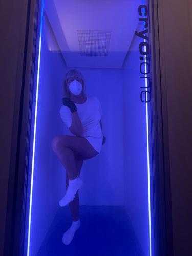 a woman is sitting in a room with a light at Pietralunga Resort in Fidenza