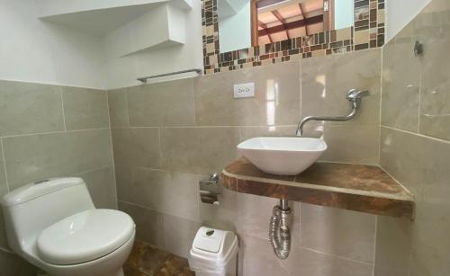 a bathroom with a sink and a toilet at Chalets Villa Marina in Copacabana
