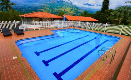 a large swimming pool with a white fence at Chalets Villa Marina in Copacabana