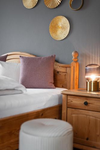 a bedroom with a bed and a table with a stool at B&B Berglift direkt an der Talstation in Bad Hofgastein