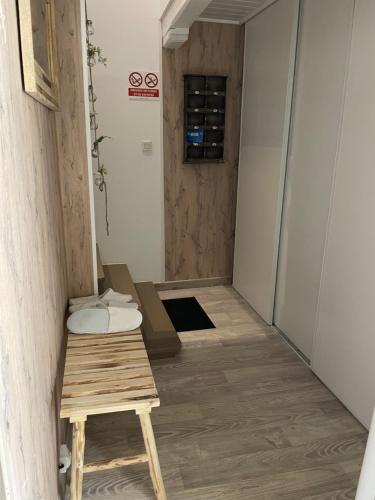 a corridor of a room with a table and a door at Au p’tit nid douillet in Guînes