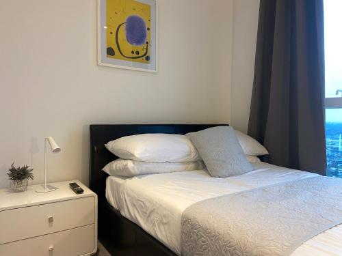 a small bedroom with a bed and a night stand at Apartment-contractors dream in Croydon