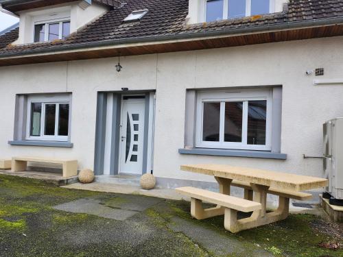a house with two benches in front of it at Cocon in Domérat