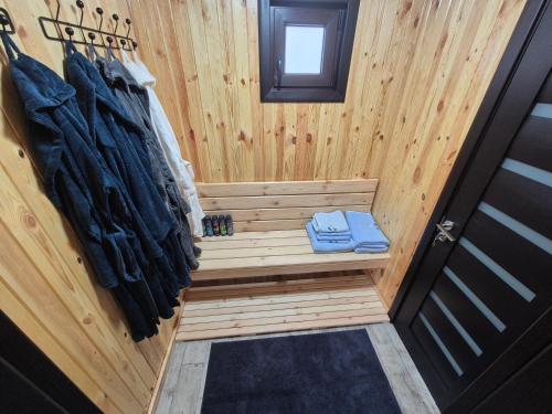 a sauna with a bench in a tiny house at Casa Izvorul Rarăului in Câmpulung Moldovenesc
