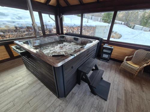 a large wooden tub in a room with a snow covered at Casa Izvorul Rarăului in Câmpulung Moldovenesc