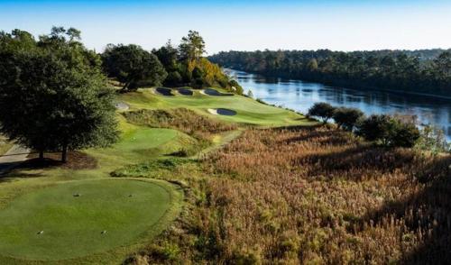 an aerial view of a golf course with a river at Cozy 2BR at Barefoot! Perfect for 4! Unit 414 in North Myrtle Beach