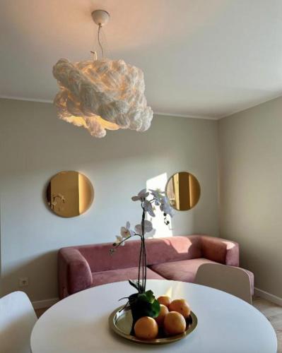 a room with a table with a bowl of fruit on it at C a r p e D i e m in Ventspils