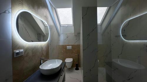 a bathroom with a sink and a mirror at Apartamenty pod Dębami - noclegi Beskid Niski in Odrzechowa